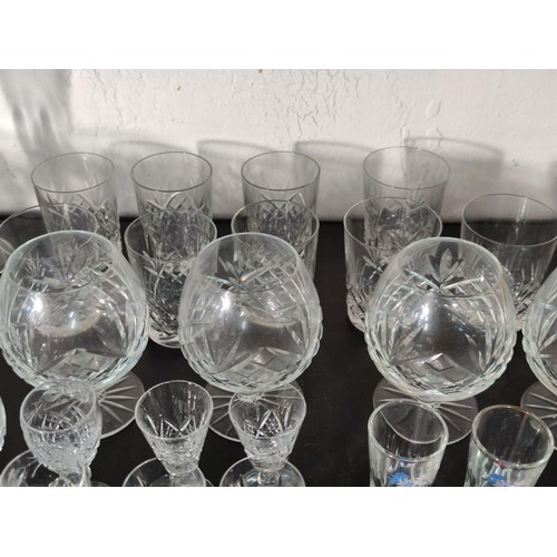 322 - A large quantity of glassware including many matching sets crystal cut etched glass sherry glasses, ... 