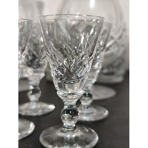 322 - A large quantity of glassware including many matching sets crystal cut etched glass sherry glasses, ... 