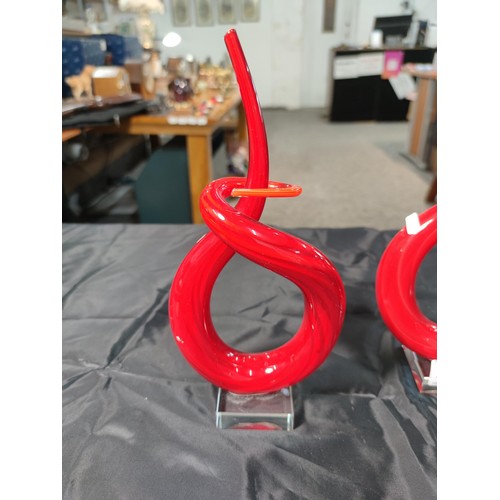 329 - A pair of Murano Venetian twisted red glass ornaments along with a pair of smokey glass vases with e... 