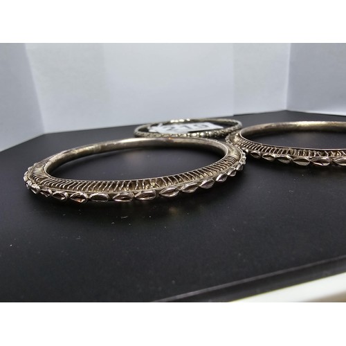 219 - A collection of 3 hand made silver bangles in the style of Kada Kangan with intricate designs to the... 