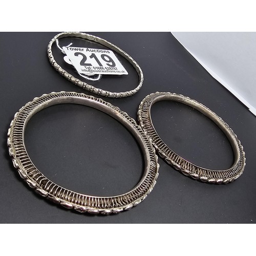 219 - A collection of 3 hand made silver bangles in the style of Kada Kangan with intricate designs to the... 