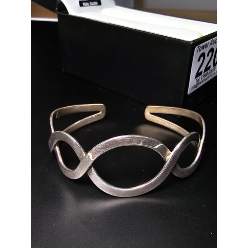 220 - A boxed real 925 silver scroll style bangle in good order.