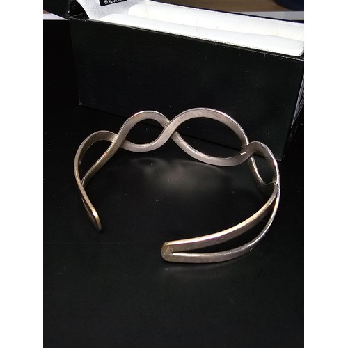 220 - A boxed real 925 silver scroll style bangle in good order.