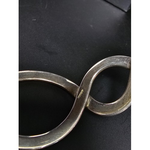 220 - A boxed real 925 silver scroll style bangle in good order.