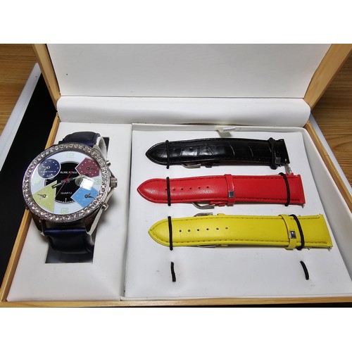 230 - A fitted boxed Alan Fried watch set including an oversized dress watch with a selection of coloured ... 