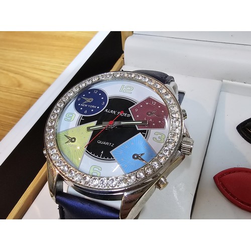 230 - A fitted boxed Alan Fried watch set including an oversized dress watch with a selection of coloured ... 