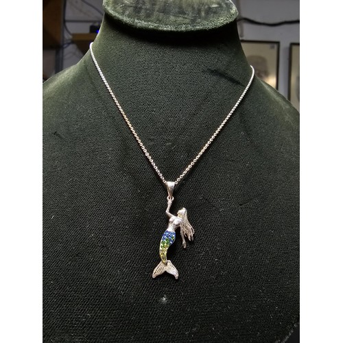 231 - A 925 silver necklace with a mermaid pendant with blue and green CZ stones on a 16