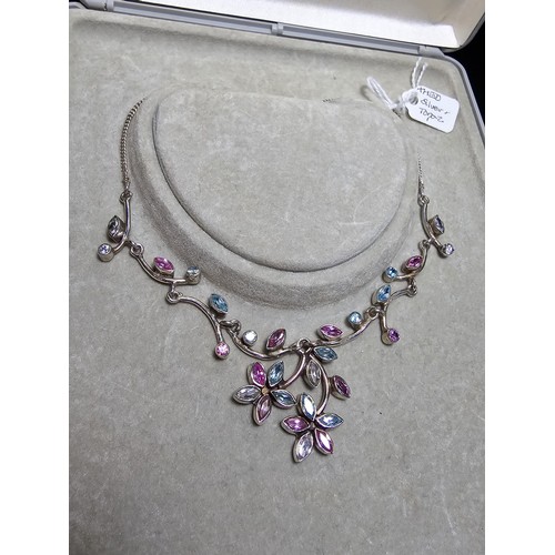 232 - A stunning 925 silver floral design necklace inset with pink white and blue CZ stones, which are spa... 