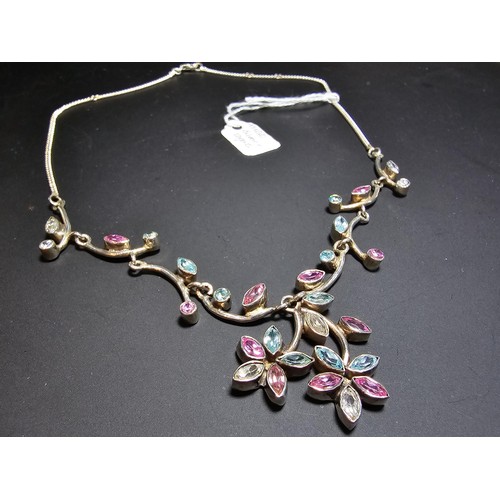 232 - A stunning 925 silver floral design necklace inset with pink white and blue CZ stones, which are spa... 