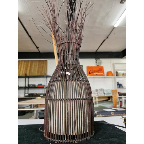 433 - A large tabletop lamp with a natural woven African fabric lamb along with a tall reed formed African... 