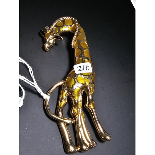 242 - A good quality large giraffe formed brooch with amber coloured decoration in overall good condition,... 