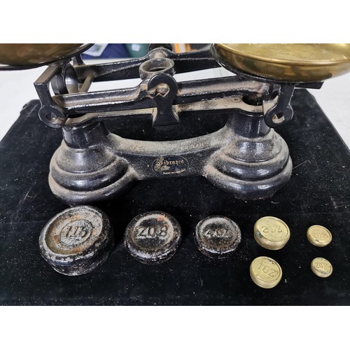 436 - A set of vintage Librasco cast iron scales complete with brass pans and weights. Weight from a quart... 