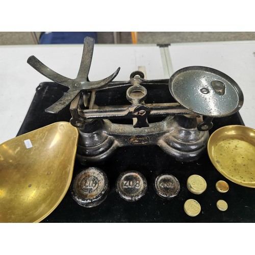 436 - A set of vintage Librasco cast iron scales complete with brass pans and weights. Weight from a quart... 