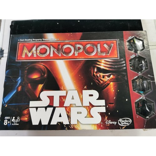 443 - A boxed Monopoly star wars game along with a Star wars Rogue one book and 2 boxed card games includi... 