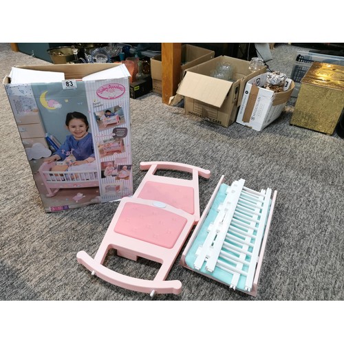 83 - A boxed baby Annabelle rocking baby crib along with an additional bagged baby crib. In working order... 