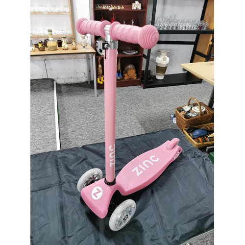 96 - A boxed zinc child's pink scooter with light up wheels. In good overall condition with adjustable ha... 