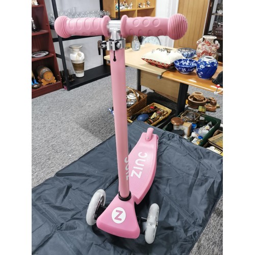 96 - A boxed zinc child's pink scooter with light up wheels. In good overall condition with adjustable ha... 