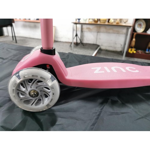 96 - A boxed zinc child's pink scooter with light up wheels. In good overall condition with adjustable ha... 