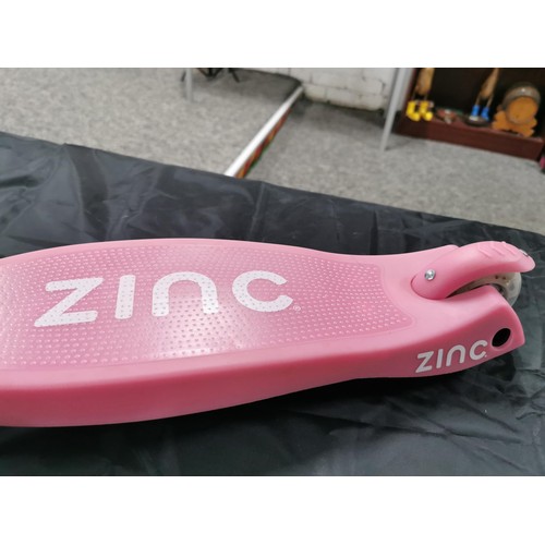 96 - A boxed zinc child's pink scooter with light up wheels. In good overall condition with adjustable ha... 