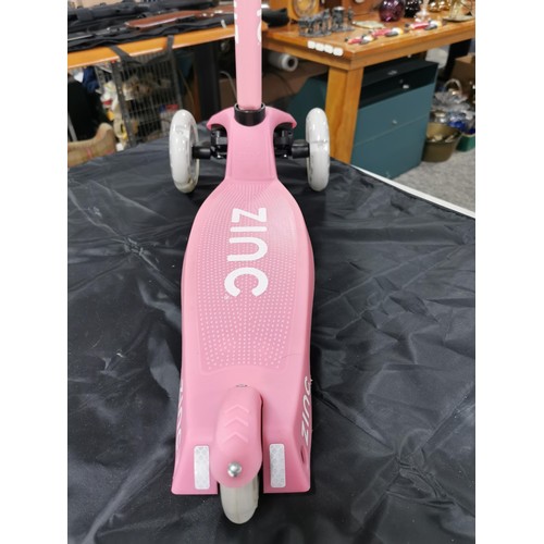 96 - A boxed zinc child's pink scooter with light up wheels. In good overall condition with adjustable ha... 