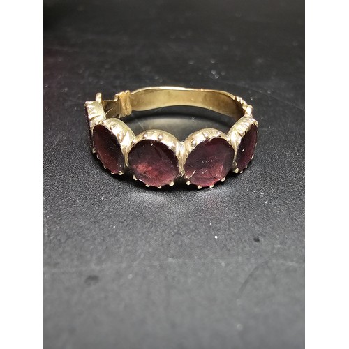 266 - 14ct Yellow Gold Ring inset with 5 Almandine Garnet stones which are faceted flat to the mount, the ... 