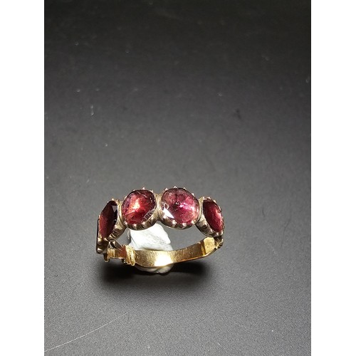 266 - 14ct Yellow Gold Ring inset with 5 Almandine Garnet stones which are faceted flat to the mount, the ... 