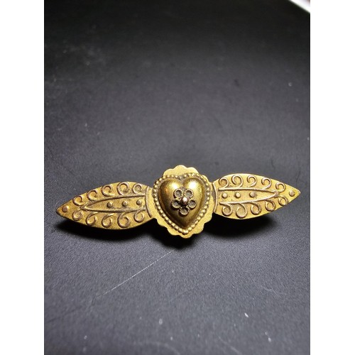 273 - An Antique 15ct Yellow Gold Brooch / Pendant having an ornate engraved design marked 15ct to the bac... 