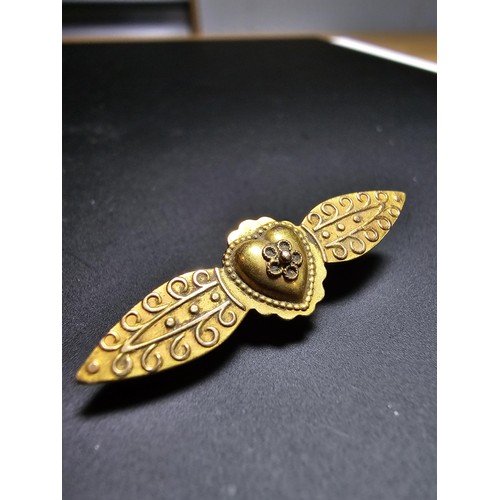 273 - An Antique 15ct Yellow Gold Brooch / Pendant having an ornate engraved design marked 15ct to the bac... 