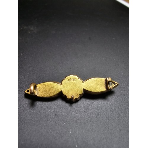 273 - An Antique 15ct Yellow Gold Brooch / Pendant having an ornate engraved design marked 15ct to the bac... 