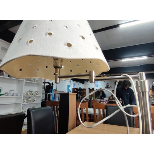 460 - A chrome floor standing lamp with concertina arm in good overall condition and complete with shade. ... 