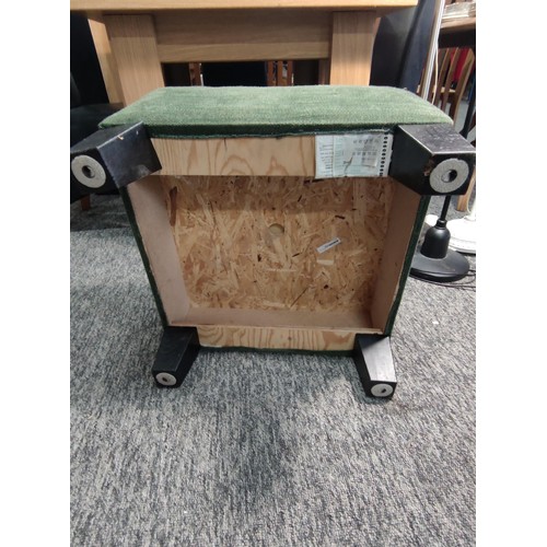 465 - An IKEA footstool in a green hard wearing material. Height 38cm and 54cm2.