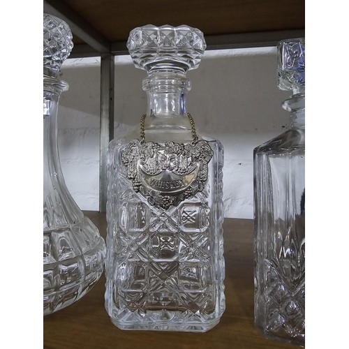 448 - A quantity of 4 pressed glass decanters including 2 port decanters and 2 whisky decanters. 1 whisky ... 