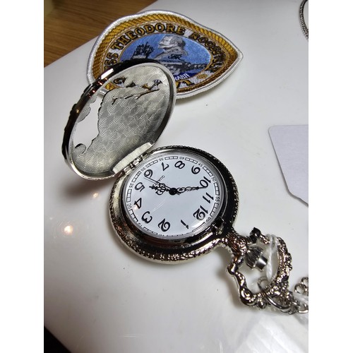 222 - As new ornate pocket watch with a locomotive design along with Siskiyou American belt buckle with a ... 