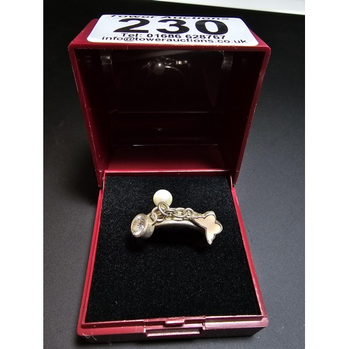 230 - 925 silver ring featuring 3x charms which includes a real pearl. in good condition boxed, size M.5