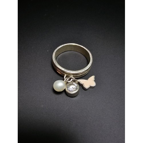 230 - 925 silver ring featuring 3x charms which includes a real pearl. in good condition boxed, size M.5