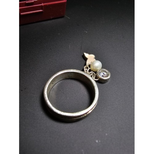 230 - 925 silver ring featuring 3x charms which includes a real pearl. in good condition boxed, size M.5