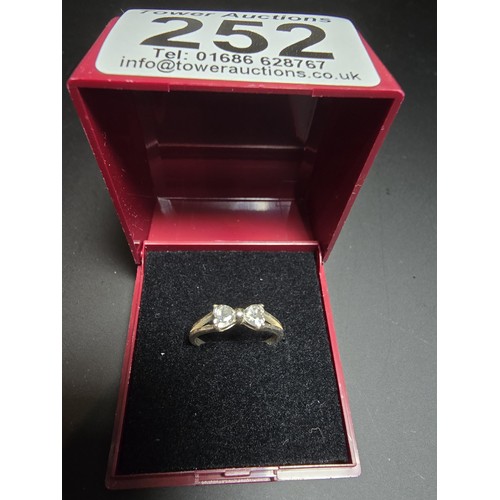 252 - 925 silver ring inset with cz crystal stones in the form of a bow, in good clean condition boxed siz... 