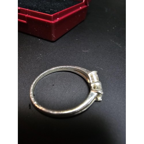 252 - 925 silver ring inset with cz crystal stones in the form of a bow, in good clean condition boxed siz... 