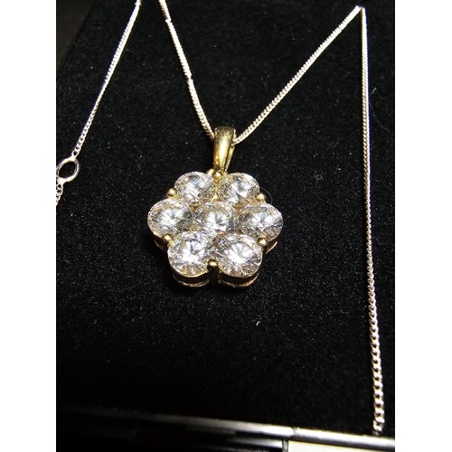 261 - Stunning gilt 925 silver flower formed pendant inset with very sparkly CZ crystal stones which catch... 