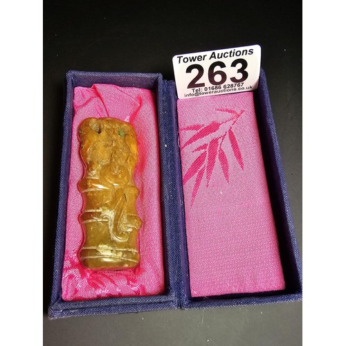 263 - Cased Carved Jade belt charm, featuring a monkey scene. height of 6.5cm width of 2.5cm