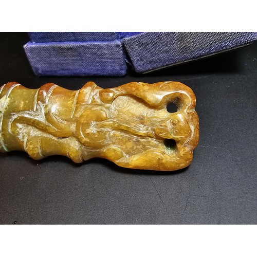 263 - Cased Carved Jade belt charm, featuring a monkey scene. height of 6.5cm width of 2.5cm