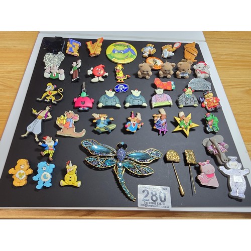 280 - A suite of collectable badges to inc. a large impressive dragonfly formed brooch inset with many spa... 