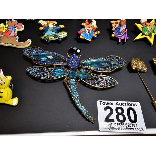 280 - A suite of collectable badges to inc. a large impressive dragonfly formed brooch inset with many spa... 