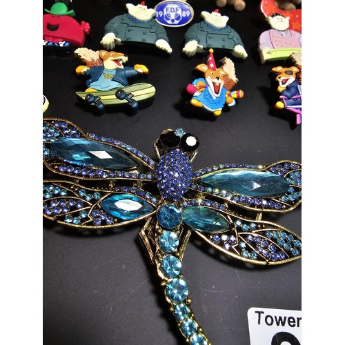 280 - A suite of collectable badges to inc. a large impressive dragonfly formed brooch inset with many spa... 