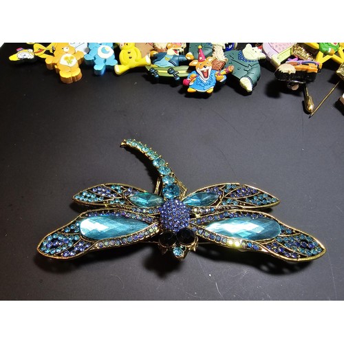 280 - A suite of collectable badges to inc. a large impressive dragonfly formed brooch inset with many spa... 