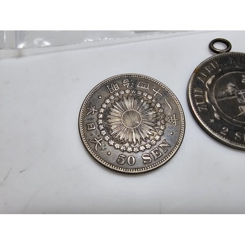 300 - 2x good antique silver coins to inc. an antique japanese 50 Sen silver coin and an antique 1896 S.Af... 