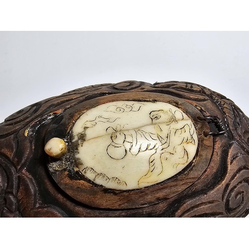 306 - An interesting antique Chinese hand carved wooden snuff box with a carved bone insert to the lid and... 