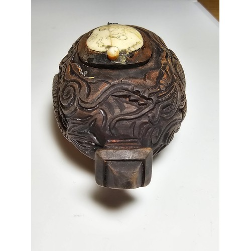 306 - An interesting antique Chinese hand carved wooden snuff box with a carved bone insert to the lid and... 