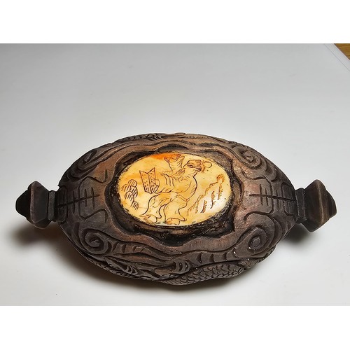 306 - An interesting antique Chinese hand carved wooden snuff box with a carved bone insert to the lid and... 