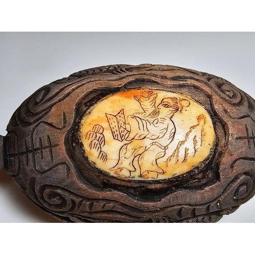 306 - An interesting antique Chinese hand carved wooden snuff box with a carved bone insert to the lid and... 